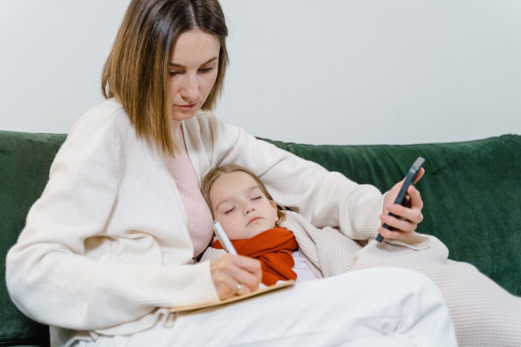 Child sleeping in lap of mother