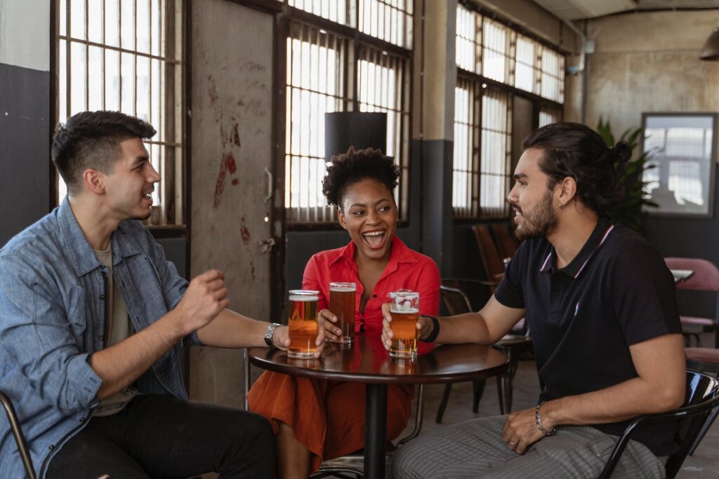 Three sitting around a table and trying to be friends.