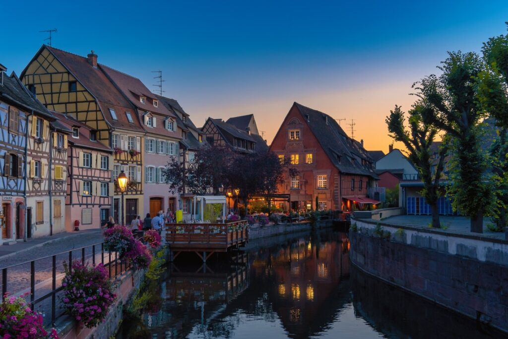 A Canal Flowing By Houses.