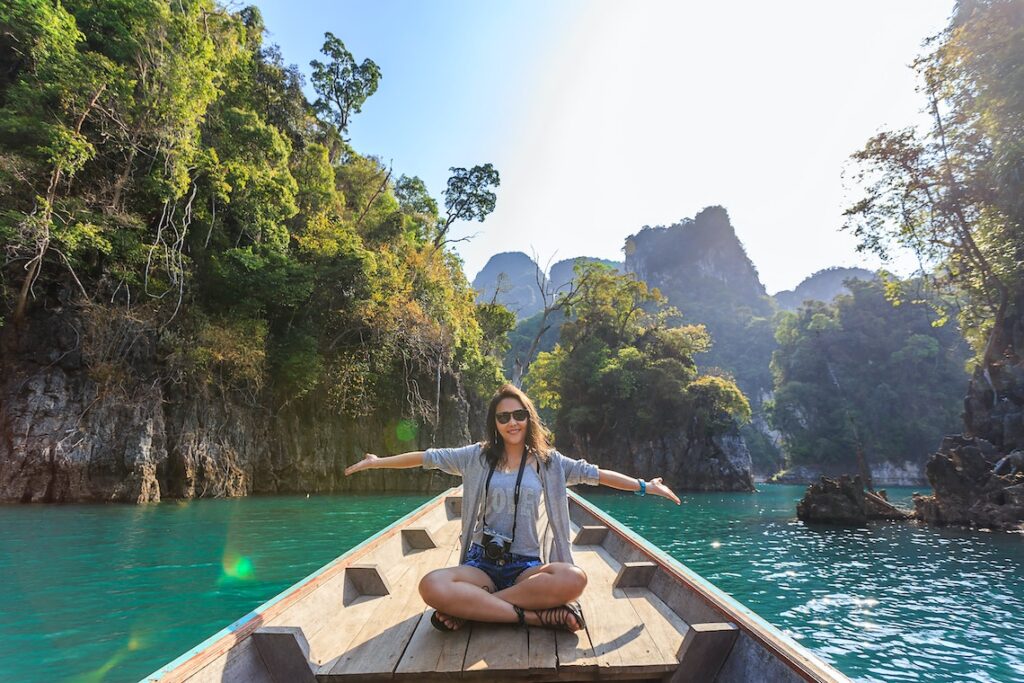 A Woman Sitting On A Boat And Enjoying.