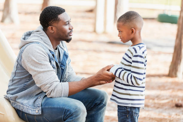 A son being advised by his father.