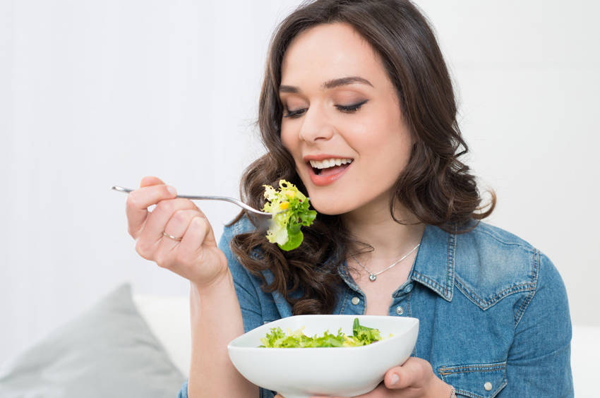 A lady chewing food properly.