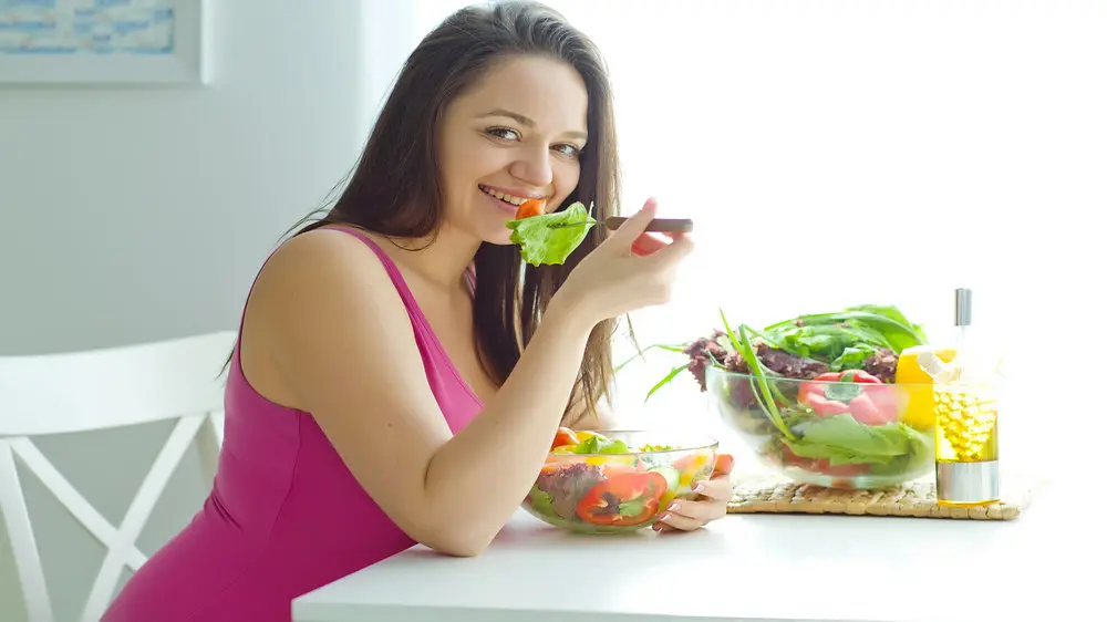 Lady eating food slowly.