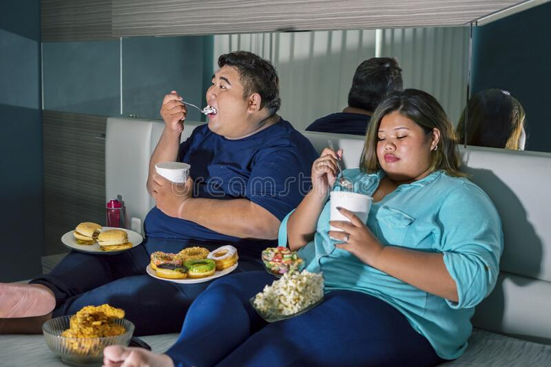 A couple consuming high calorie food.