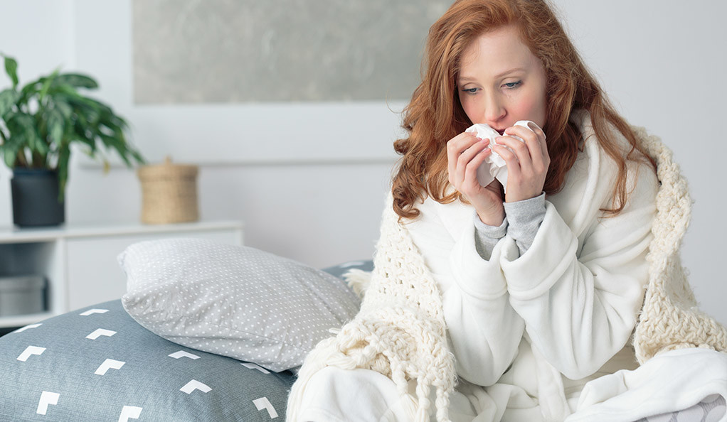 A lady suffering from cough and cold.