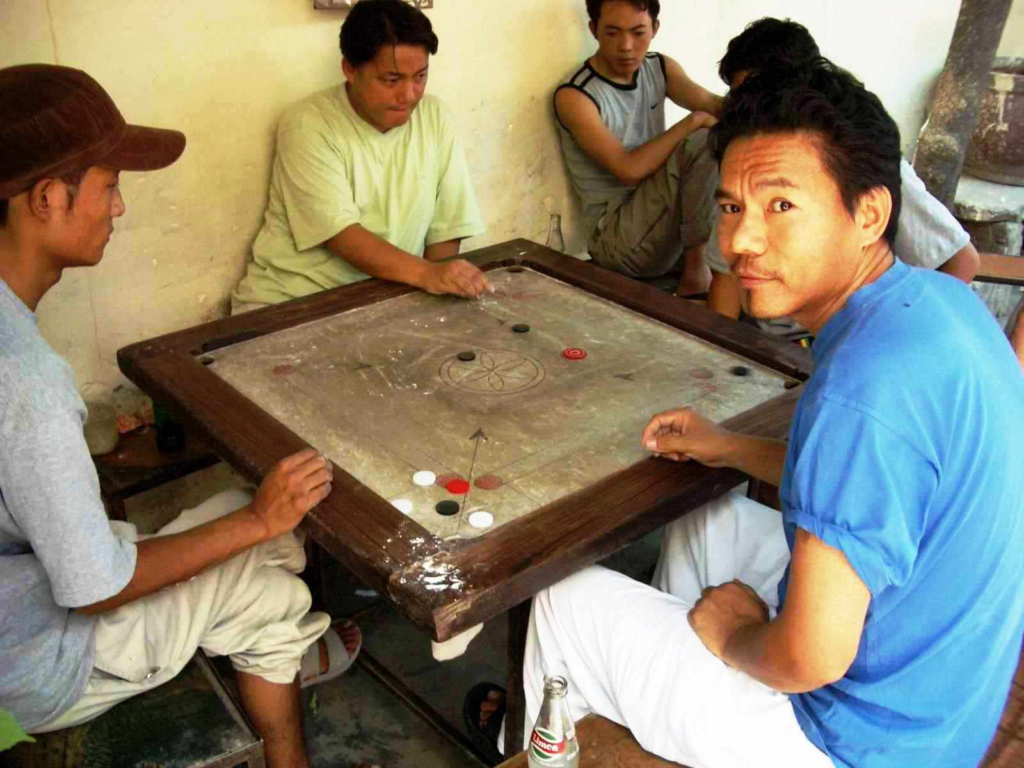 Men playing carom board.