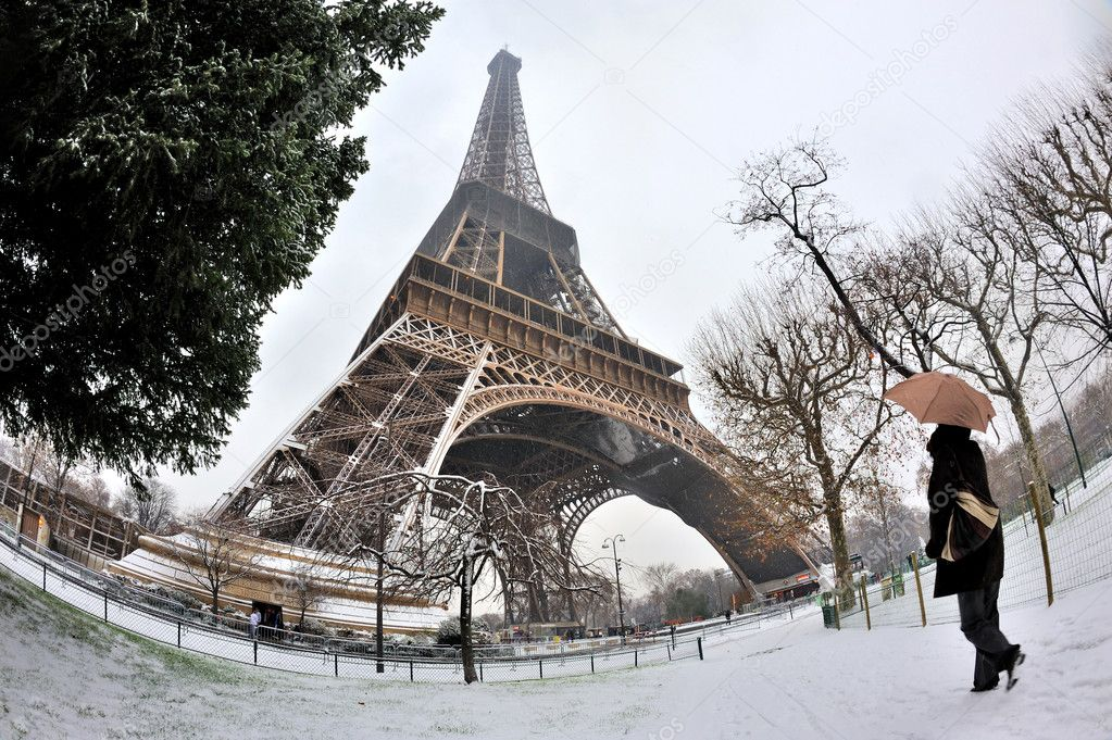 Lady enjoying snowfall in Paris.