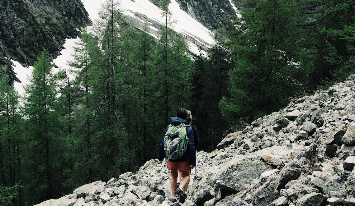 A person walking on rocky trek.