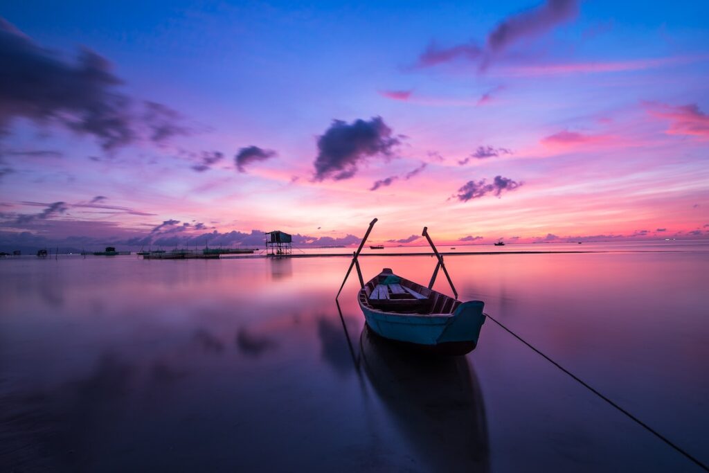 Blue And White Boat In Water.